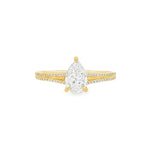 Pear-shaped diamond engagement ring in yellow gold with detailed band accents.