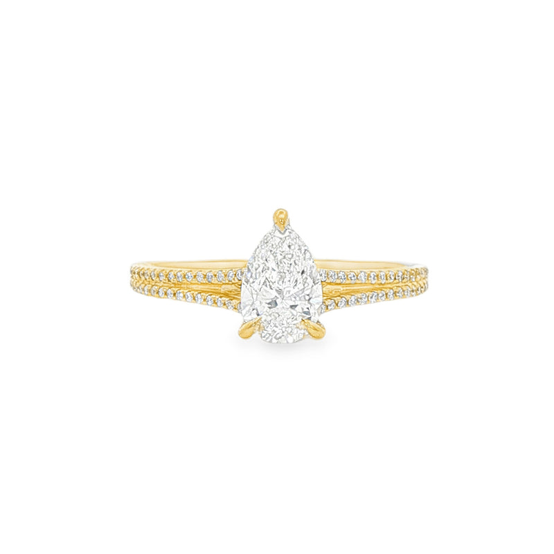 Pear-shaped diamond engagement ring in yellow gold with detailed band accents.