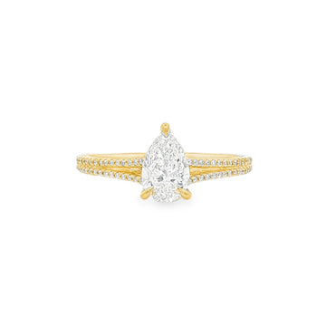 Pear-shaped diamond engagement ring in yellow gold with detailed band accents.