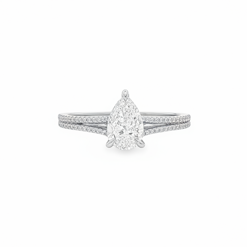 Pear-shaped diamond engagement ring in yellow gold with detailed band accents.