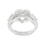 White gold engagement ring with heart halo and three diamond stones, elegant design.