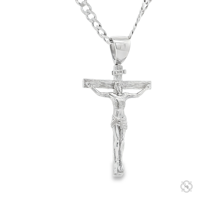 Silver crucifix pendant depicting Jesus on a Cuban curb chain necklace.