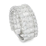 Wide white gold band ring with baguette and round diamond cluster detailing.