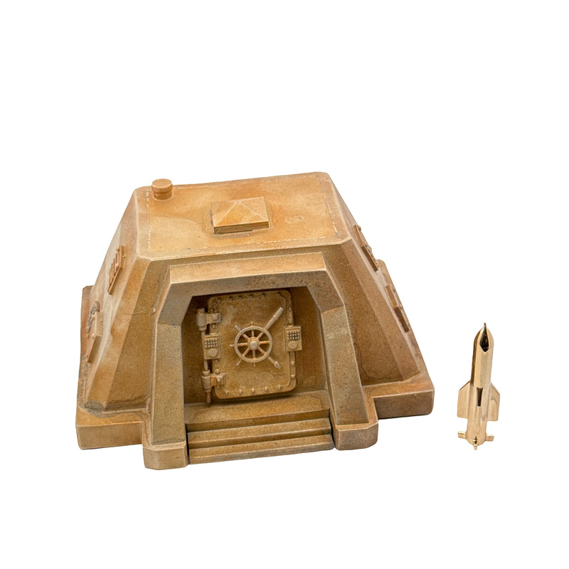 Gold-colored bunker-shaped collectible set with detailed vault door and matching miniature missile.