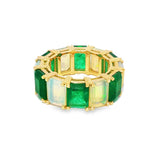 Yellow gold eternity ring with alternating rectangular emerald and opal gemstones.