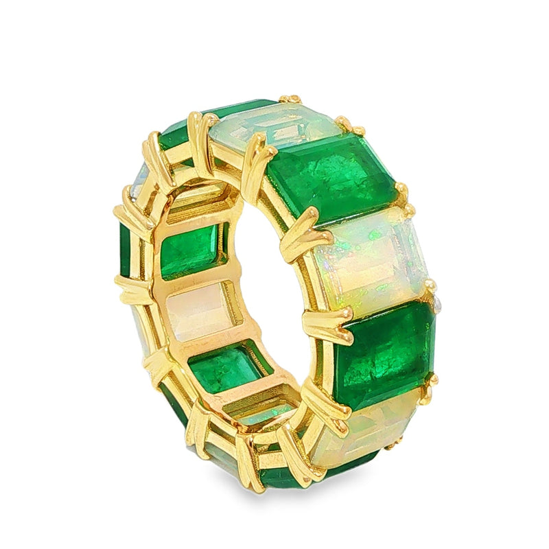Yellow gold eternity ring with alternating emerald and opal rectangular stones.