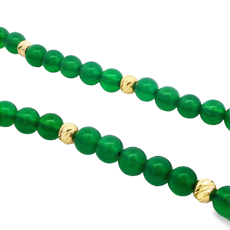 Green agate gemstone beads with textured gold spacers necklace close-up.