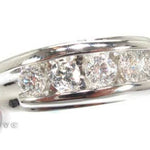 Men's white gold wedding band with channel-set round diamonds across the center.