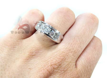 Men's white gold wedding band with channel-set round diamonds across the center.