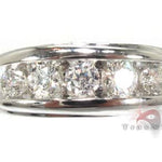 Men's white gold wedding band with channel-set round diamonds across the center.