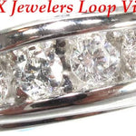 Men's white gold wedding band with channel-set round diamonds across the center.