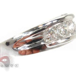 Men's white gold wedding band with channel-set round diamonds across the center.