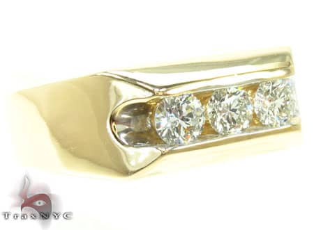 Yellow gold men's band featuring a row of three round brilliant diamonds on top