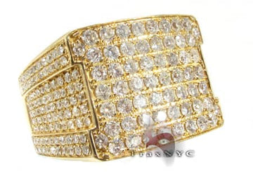 Wide yellow gold men's ring with multiple rows of small round diamonds