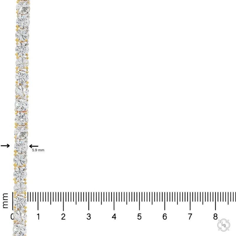 Yellow gold tennis chain with alternating upside down round diamonds.