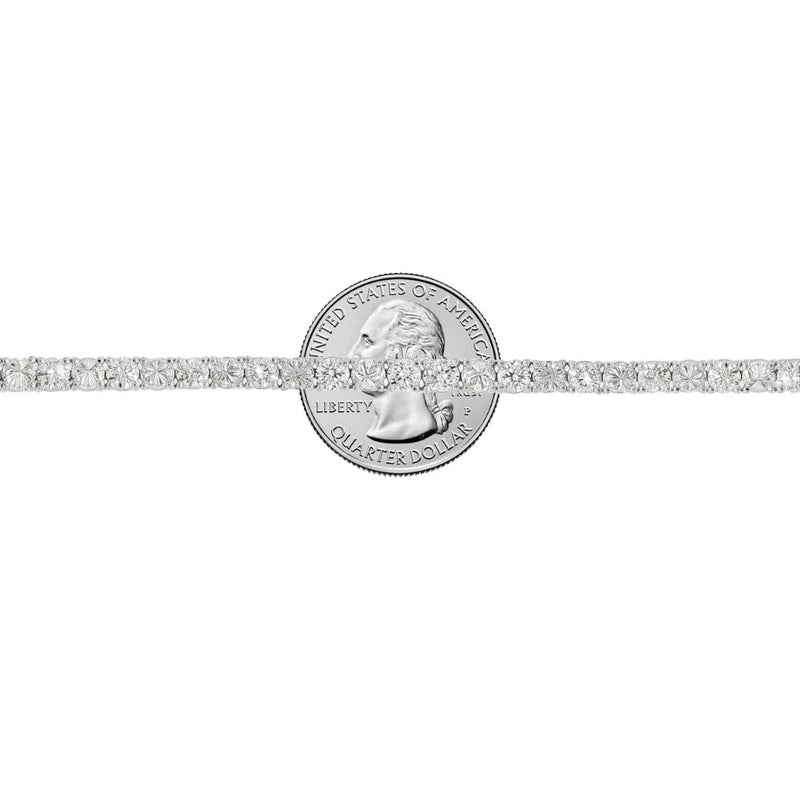 White gold tennis bracelet with alternating upside down round diamonds in a sleek setting.