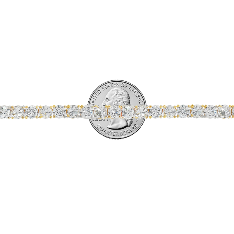 Yellow gold tennis chain with alternating upside down round diamonds.