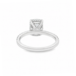 Silver engagement ring with round diamond center and intricate side detailing.
