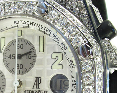 Audemars Piguet Royal Oak men's watch with diamond bezel and silver chronograph dial.