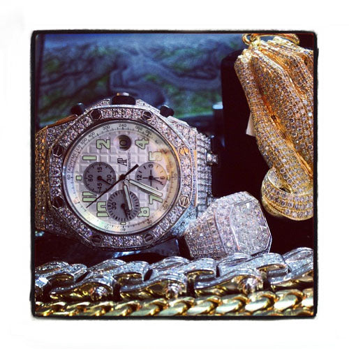 Audemars Piguet Royal Oak men's watch with diamond bezel and silver chronograph dial.