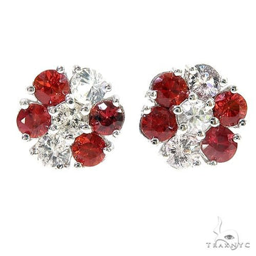Cluster flower earrings with red and clear sapphire gemstones in white metal setting.