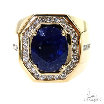 Yellow gold men's ring with large oval sapphire and halo of small diamonds.