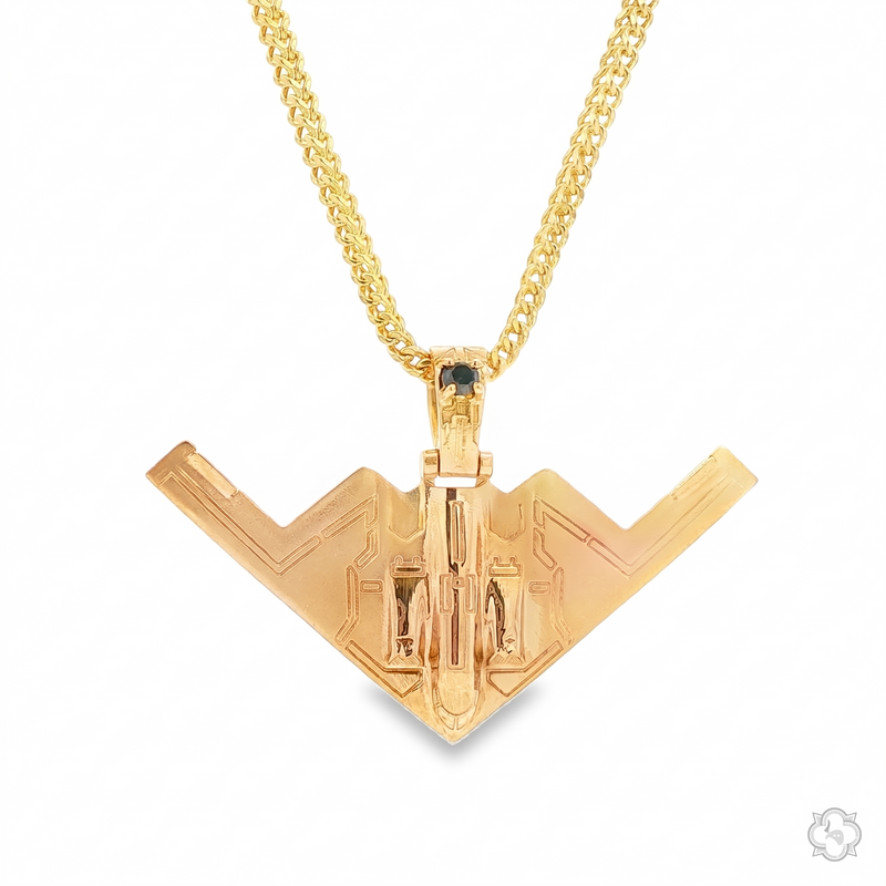 Gold B-2 Bomber pendant with black diamond detail on a matching gold chain.