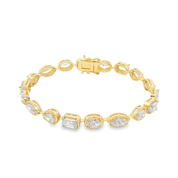 Yellow gold tennis bracelet featuring multi-shape sparkling diamonds in assorted cuts.