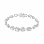 Yellow gold tennis bracelet featuring multi-shape sparkling diamonds in assorted cuts.