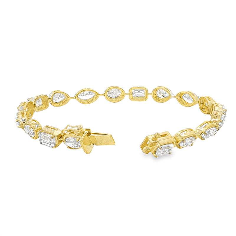 Yellow gold tennis bracelet featuring multi-shape sparkling diamonds in assorted cuts.