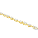 Yellow gold tennis bracelet featuring multi-shape sparkling diamonds in assorted cuts.