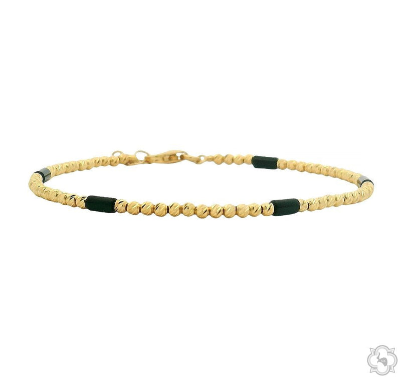 Beaded gold bracelet in 14k yellow gold – close-up of uniform bead links on neutral background