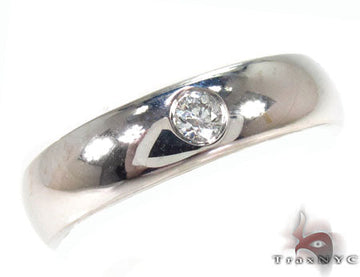 White gold men's engagement ring with a single round diamond at the center
