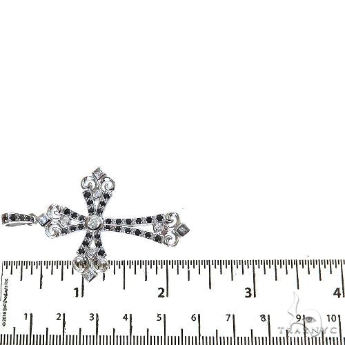 Black diamond cross pendant with white diamonds, measuring about 2 inches wide