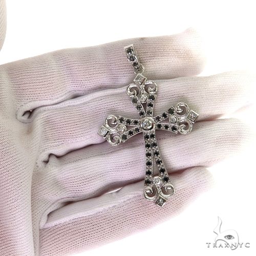14K Gold Black Diamond Cross Pendant, held in the hand