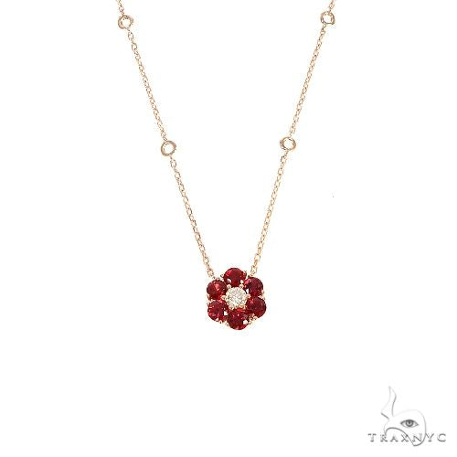 Yellow gold necklace with blood red sapphire flower pendant and central diamond detail