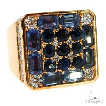 Yellow gold pinky ring with blue sapphires and small diamonds in a square setting.