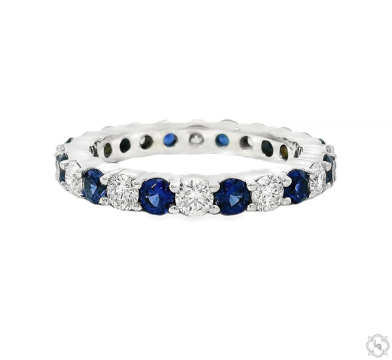 White gold eternity band with alternating blue sapphires and round diamonds