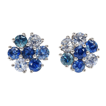 Small sapphire and diamond cluster flower stud earrings in white gold setting.