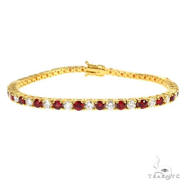 Candy Cane tennis bracelet in 14k gold with alternating red sapphires and white diamonds, full-length wrist view