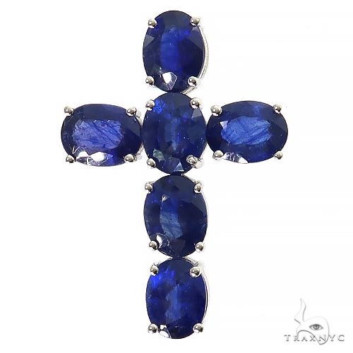 Silver cross pendant with six deep blue oval sapphire gemstones in prong settings