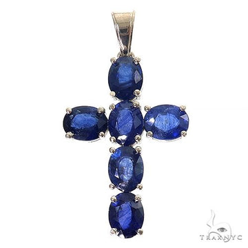 .925 silver cross pendant with six deep blue oval sapphire gemstones.