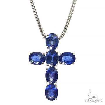 Oval blue sapphire cross pendant set in polished .925 silver with silver chain.