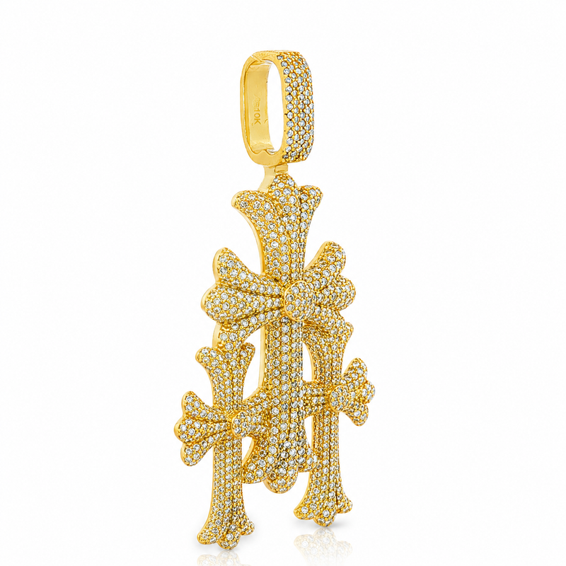 Gold triple cross pendant with pavé diamond accents and polished finish