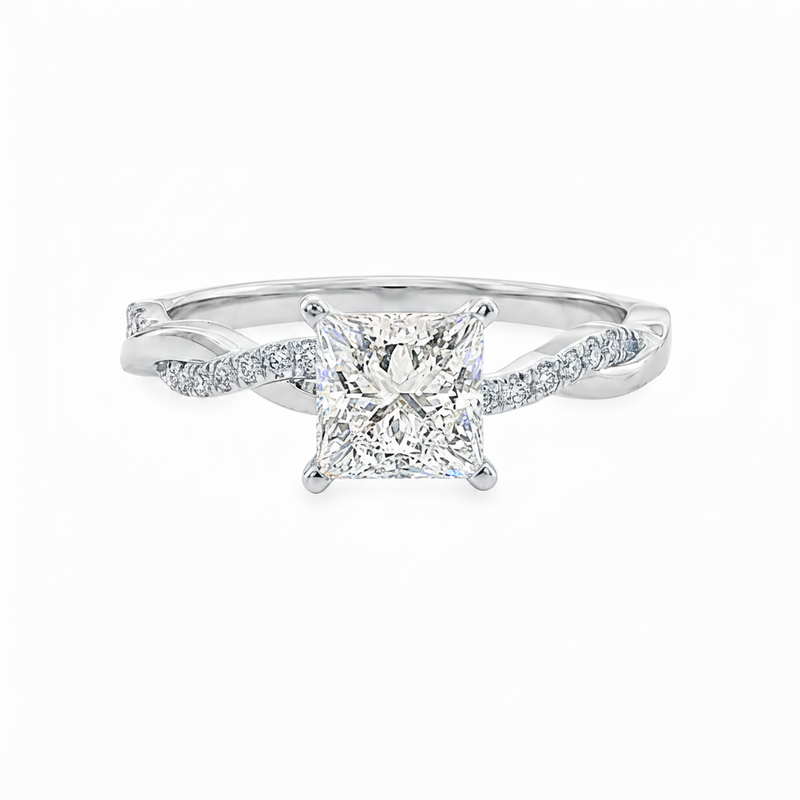 White gold engagement ring with a princess cut diamond center and pavé band accents.