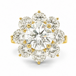 Yellow gold ring with central round diamond surrounded by eight smaller diamonds in floral design.