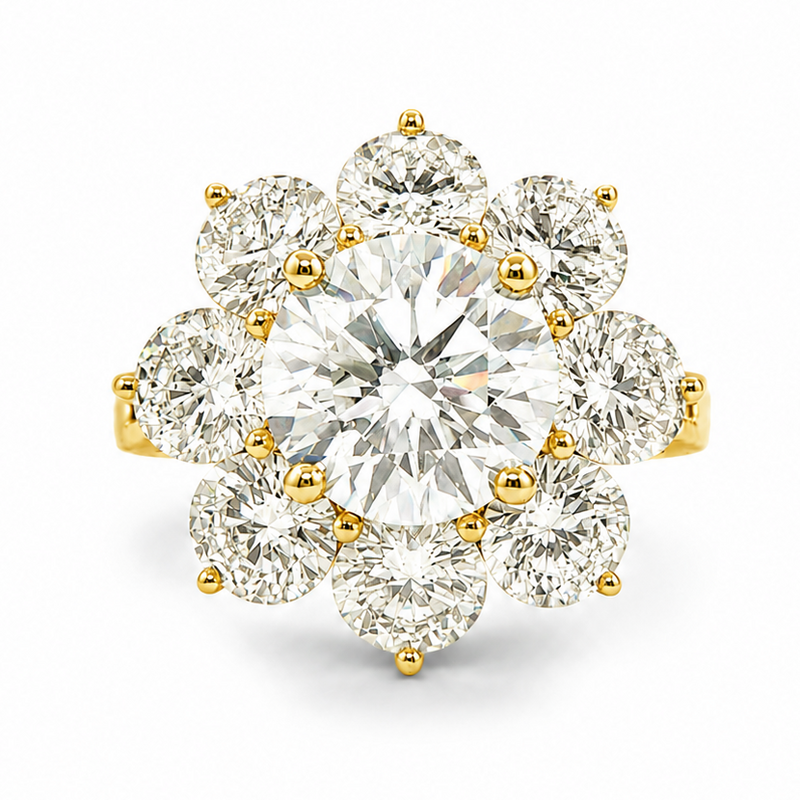 Yellow gold ring with central round diamond surrounded by eight smaller diamonds in floral design.