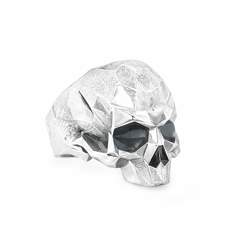 Sterling silver ring featuring a faceted skull design with angular, geometric surfaces across the head