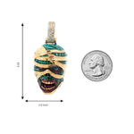 Gold mummified zombie pendant with green glow-in-the-dark enamel and diamond accents, 1 inch tall.