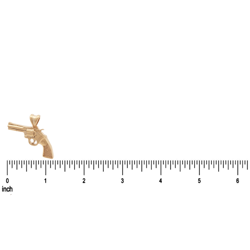 14K gold revolver pendant with detailed grip and barrel design on inch ruler background.